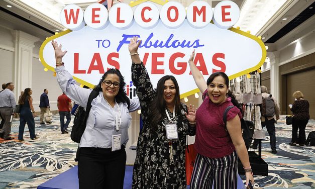 IMEX America attendees pose in front of a Welcome to Las Vegas sign. Photo: IMEX Group